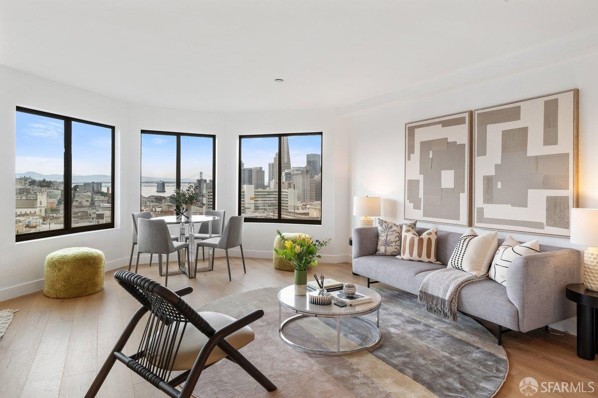 a living room with furniture and floor to ceiling windows