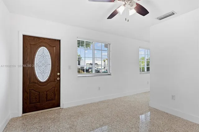 a view of a livingroom with furniture and chandelier fan