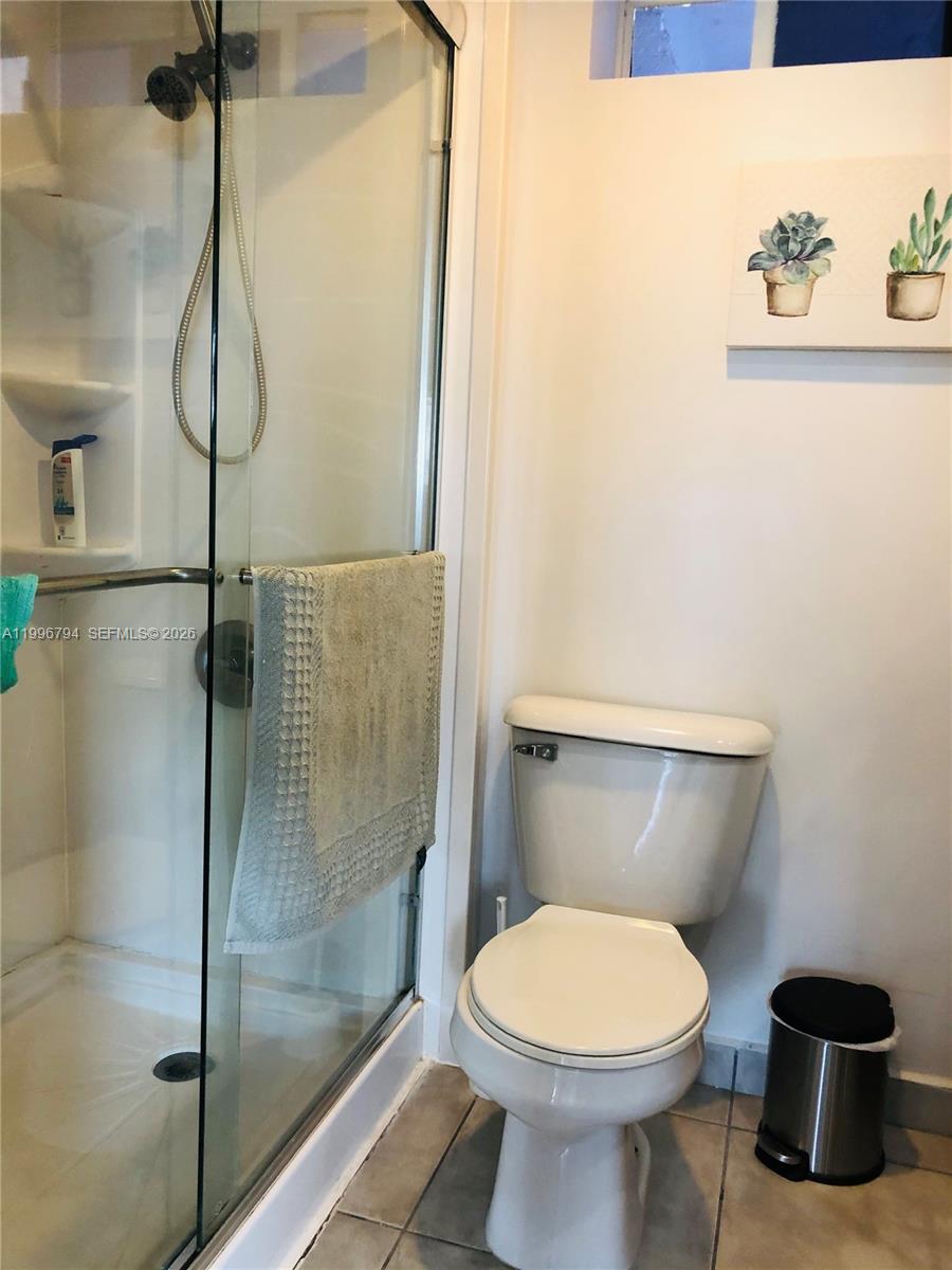 650 Northeast 64th Street, Unit G609 Miami, FL 33138 - Photo 14 of 15 a bathroom with a toilet and a shower