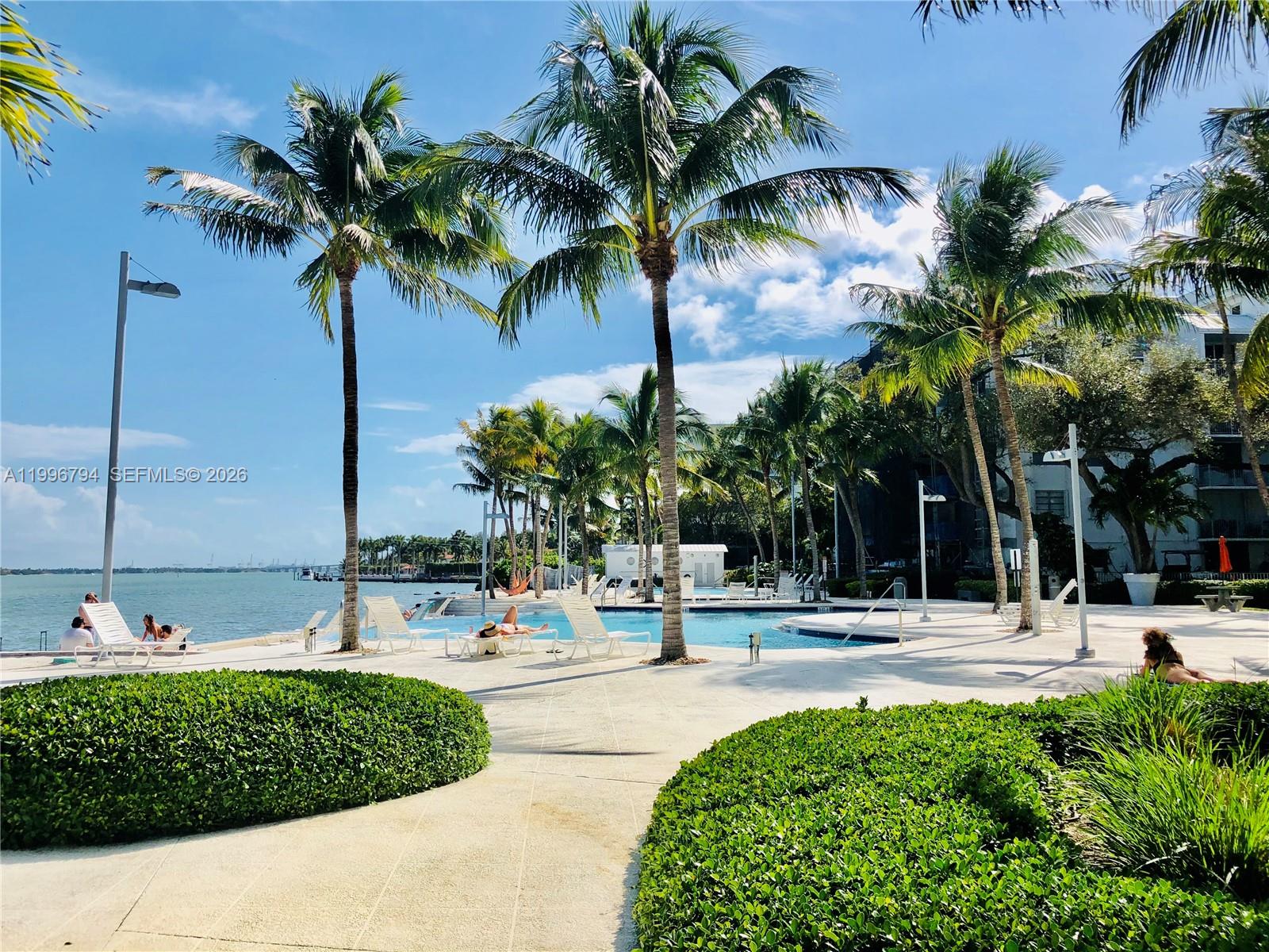 650 Northeast 64th Street, Unit G609 Miami, FL 33138 - Photo 5 of 15 a view of a yard and palm tree