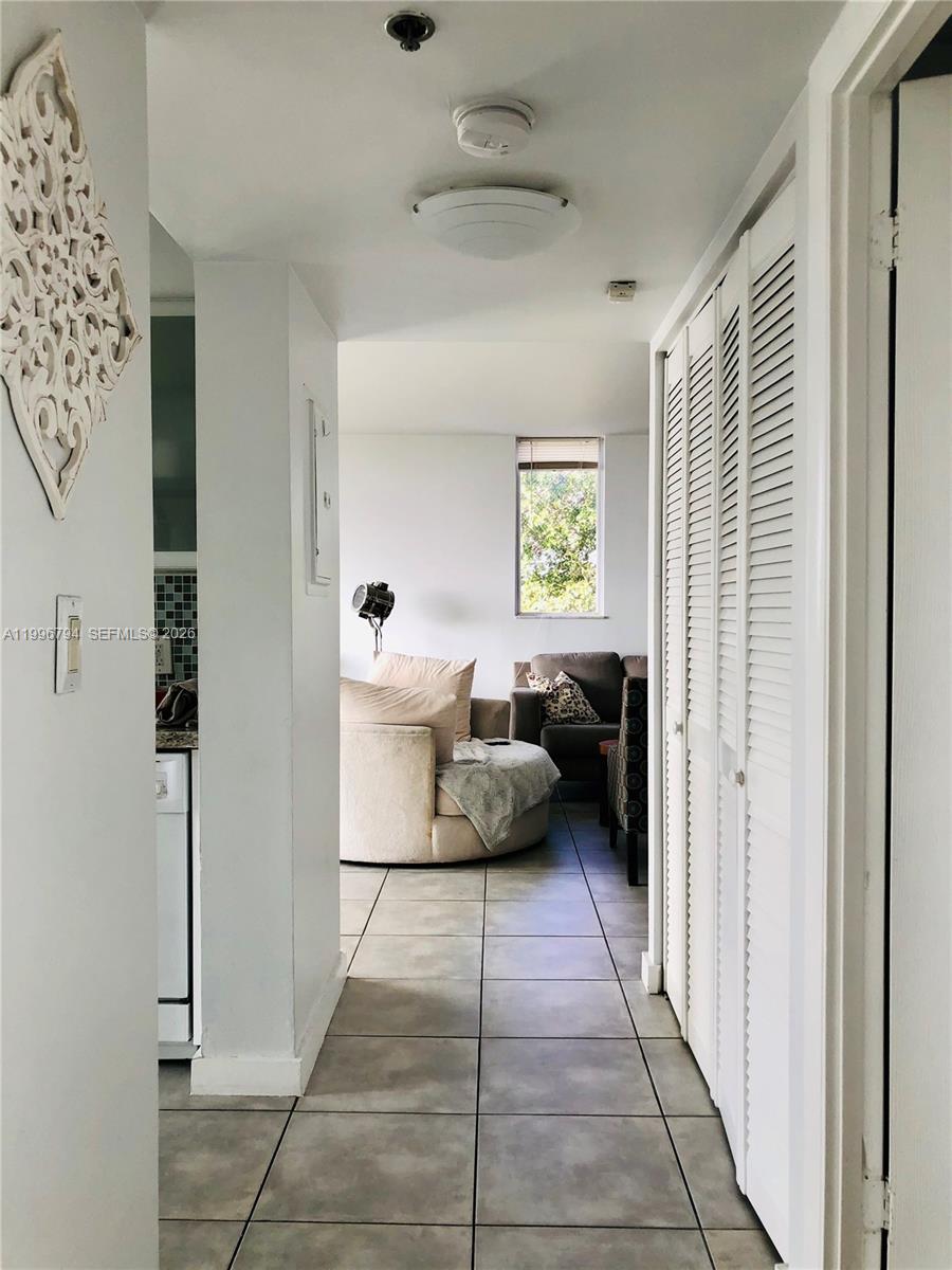 650 Northeast 64th Street, Unit G609 Miami, FL 33138 - Photo 7 of 15 a living room with furniture and a window