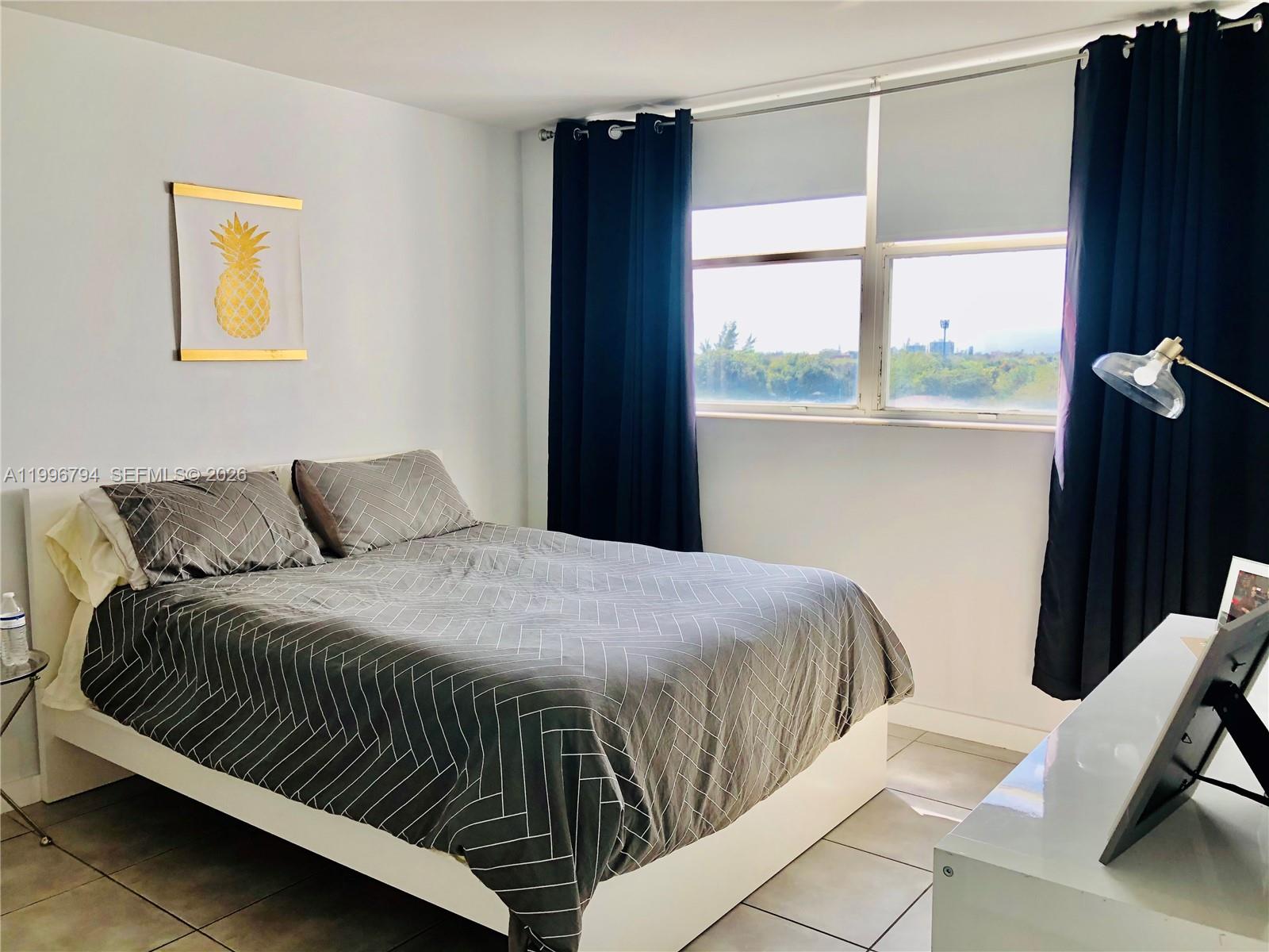 650 Northeast 64th Street, Unit G609 Miami, FL 33138 - Photo 8 of 15 a bedroom with a bed window and a window