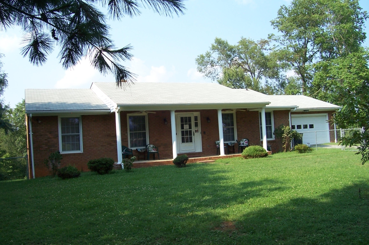 a front view of a house with a garden and porch