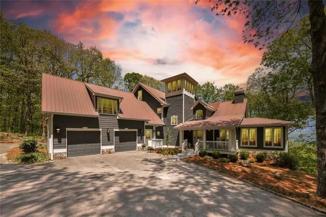 a front view of a house with a yard and table and chairs