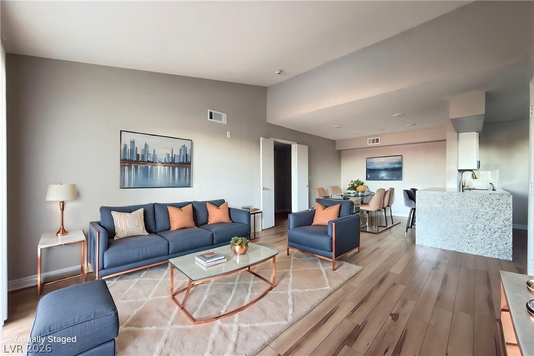 An open-concept living area boasts rich hardwood floors and an inviting atmosphere.