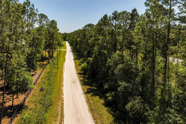 an aerial view of a houses with yard