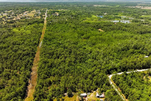a view of a field with an ocean view