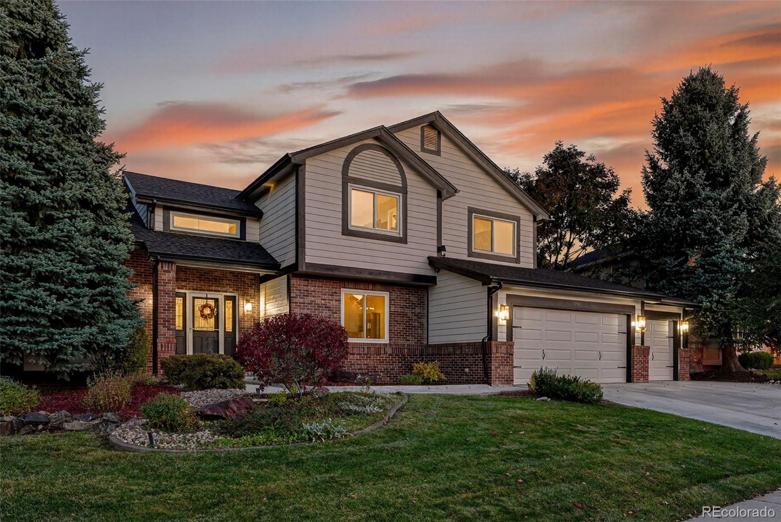 9910 Ashleigh Way Highlands Ranch, CO 80126 - Photo 1 of 49 front view of a house with a yard
