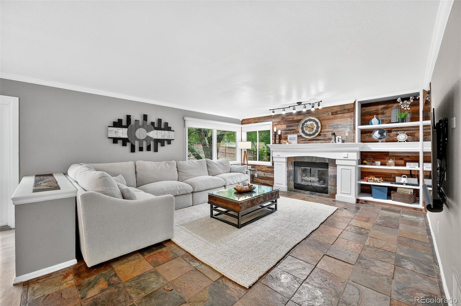 9910 Ashleigh Way Highlands Ranch, CO 80126 - Photo 11 of 49 a living room with furniture and a fireplace