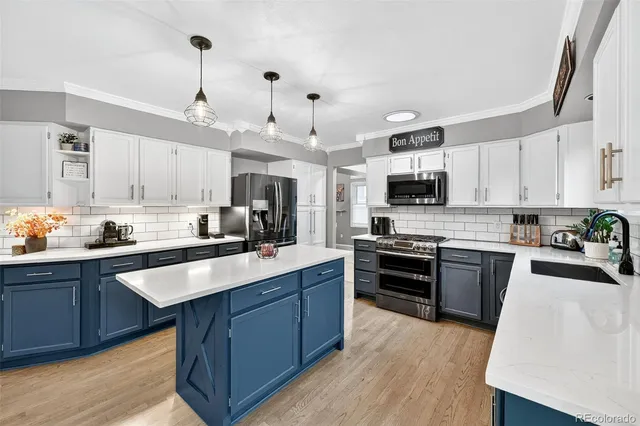 a large kitchen with stainless steel appliances lots of counter space sink and cabinets