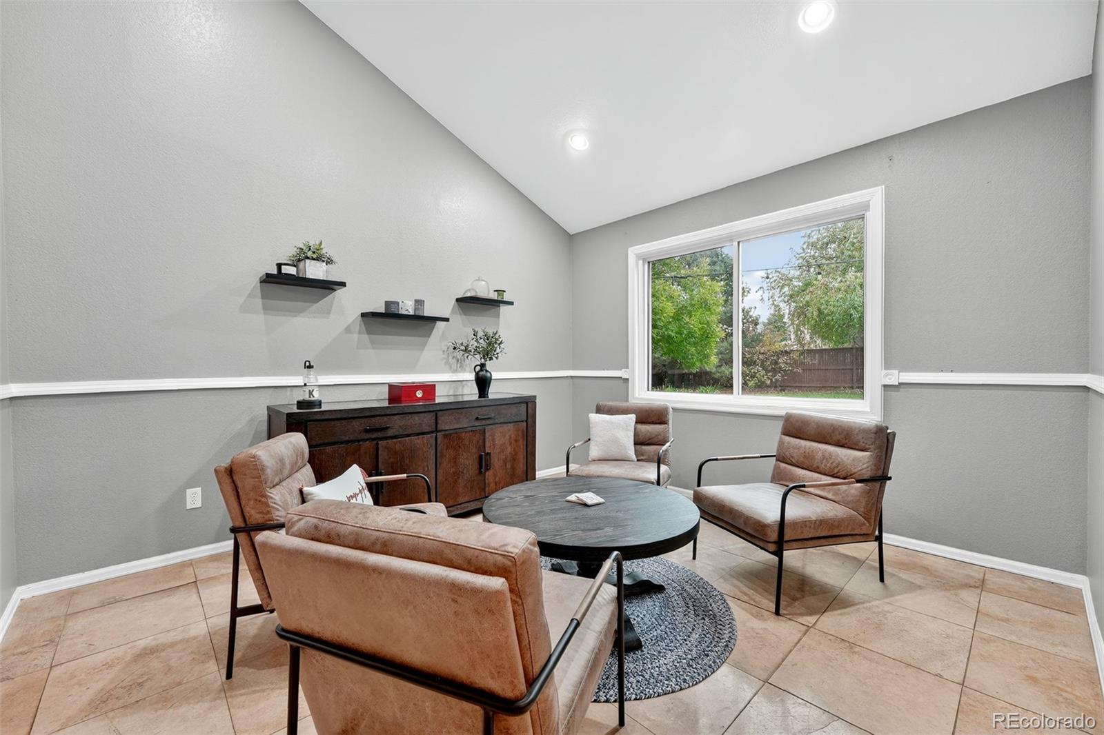 9910 Ashleigh Way Highlands Ranch, CO 80126 - Photo 18 of 49 a living room with furniture and a window