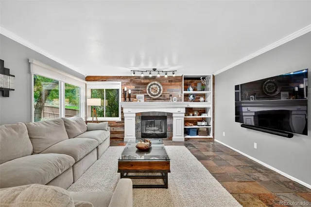 a living room with furniture and a fireplace