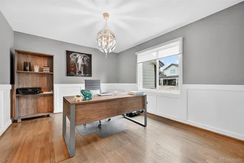 a view of a workspace with furniture and a chandelier