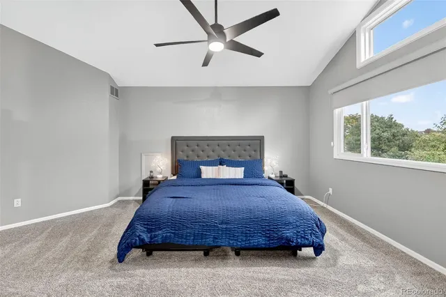 a bedroom with a bed a window and a chandelier