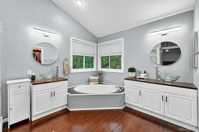 a bathroom with a double vanity sink and mirror