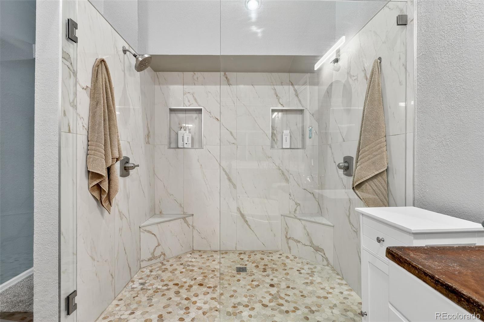 9910 Ashleigh Way Highlands Ranch, CO 80126 - Photo 27 of 49 a bathroom with a granite countertop shower a sink and a toilet