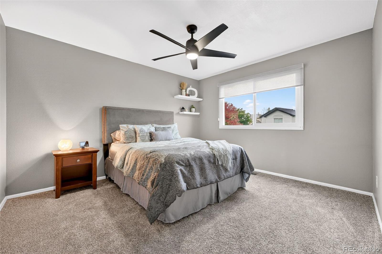 9910 Ashleigh Way Highlands Ranch, CO 80126 - Photo 29 of 49 a bedroom with a bed and painting on the wall