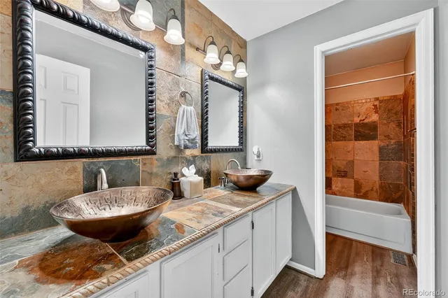a bathroom with a granite countertop sink and a mirror