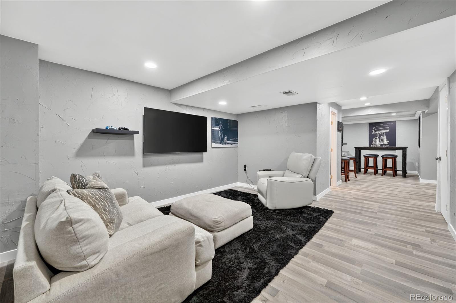 9910 Ashleigh Way Highlands Ranch, CO 80126 - Photo 32 of 49 a living room with furniture and a flat screen tv