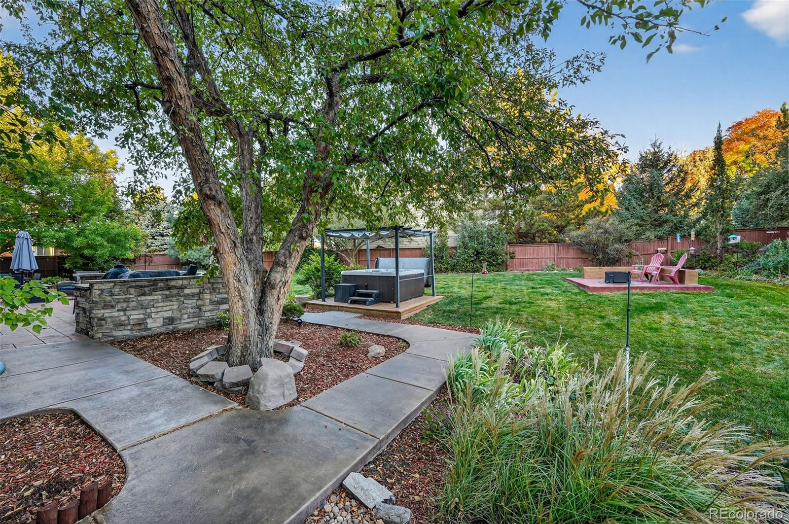 9910 Ashleigh Way Highlands Ranch, CO 80126 - Photo 36 of 49 a front view of a house with a garden and tree