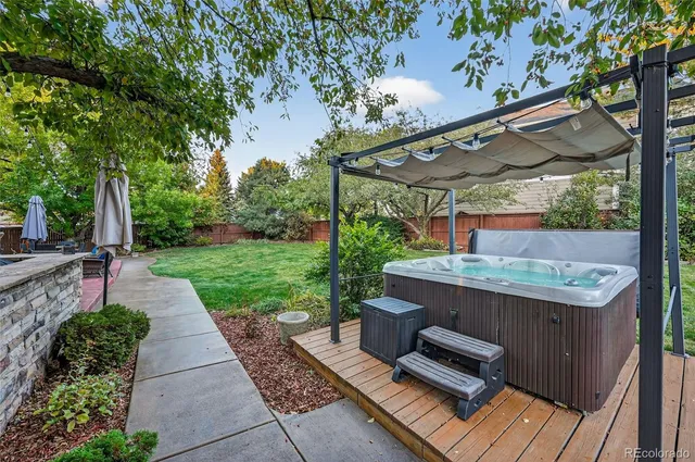 a view of a patio with table and chairs potted plants with wooden floor