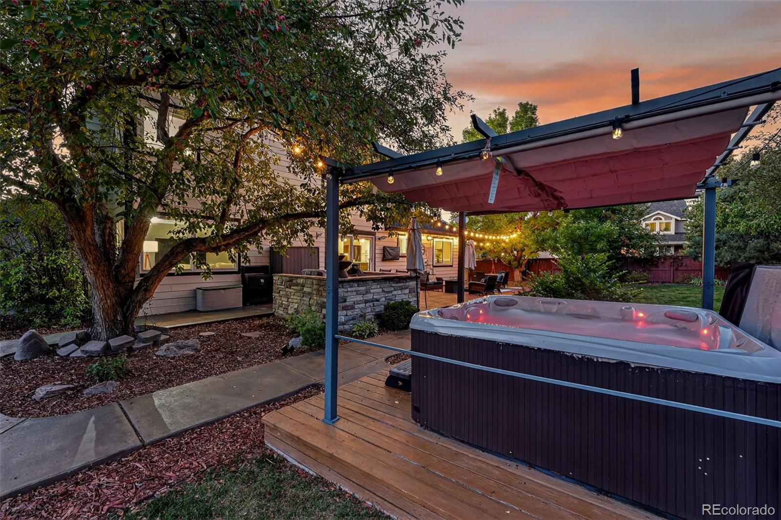 9910 Ashleigh Way Highlands Ranch, CO 80126 - Photo 39 of 49 a view of a with table and chairs under an umbrella