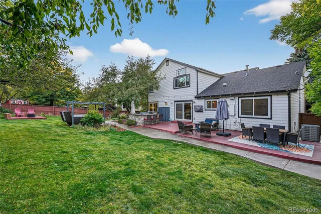 a view of a house with backyard sitting area and garden
