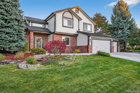 a front view of house with yard and green space