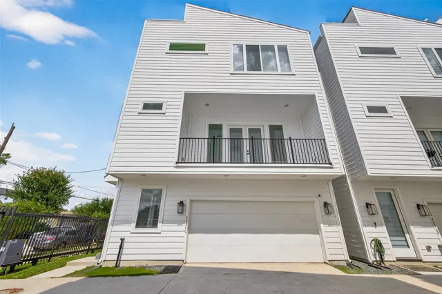 a view of a white building among the street