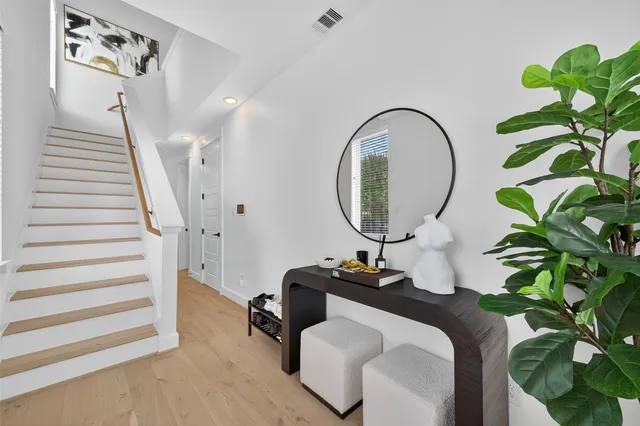 a living room with furniture and a mirror