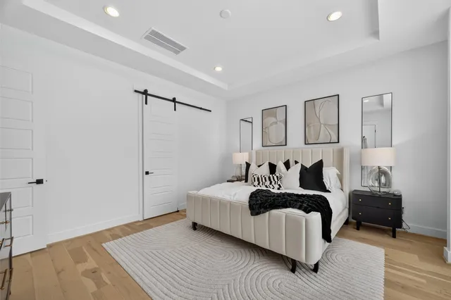 a bedroom with a bed and a night stand