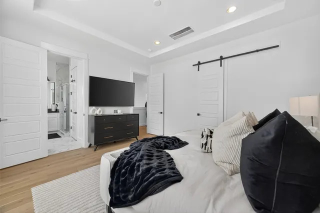 a bedroom with a bed and a flat screen tv