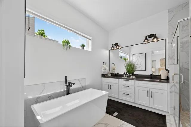 a bathroom with a bathtub a sink and a mirror