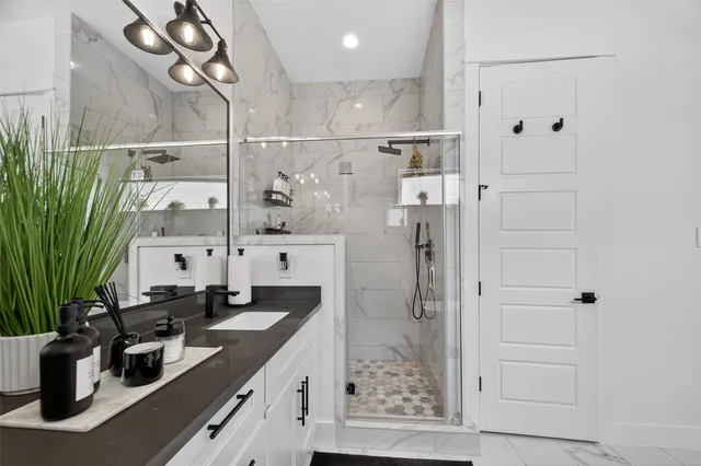 a kitchen with white cabinets and refrigerator