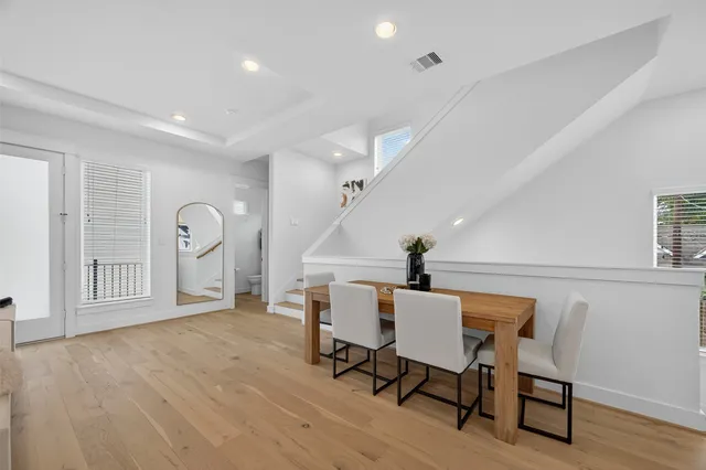a view of a dining room with furniture and wooden floor