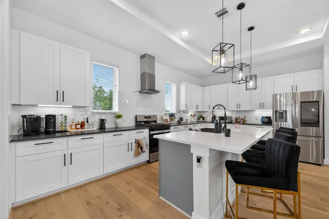 a kitchen with stainless steel appliances kitchen island granite countertop a sink and cabinets
