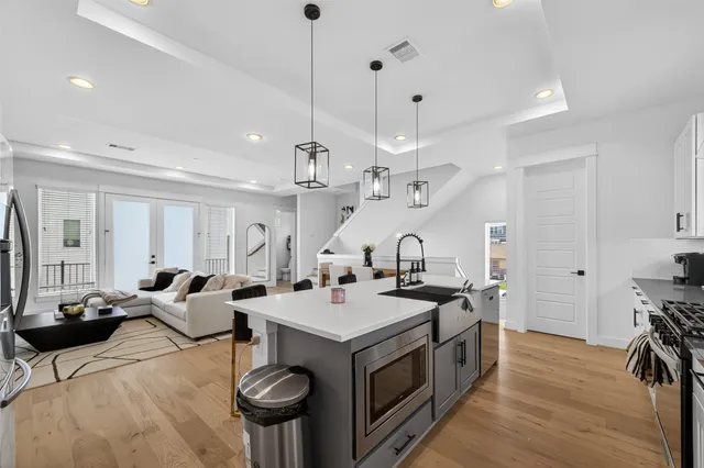 a open kitchen with stainless steel appliances granite countertop a stove and a refrigerator