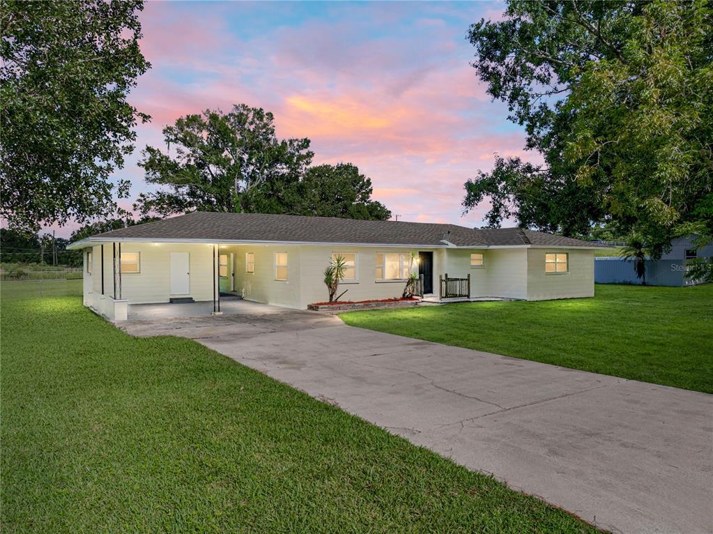 1015 Sutton Road Lakeland, FL 33810 - Photo 1 of 1 a front view of house with yard and green space