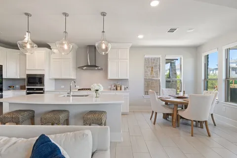 a living room with furniture and a kitchen