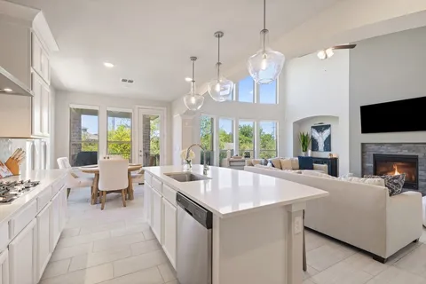 a kitchen with kitchen island granite countertop a sink stainless steel appliances a counter space and cabinets