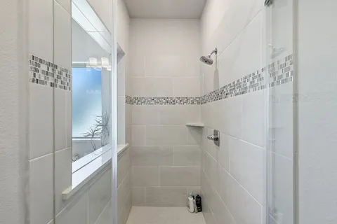 a large spacious bathroom with a granite countertop sink mirror and bathtub