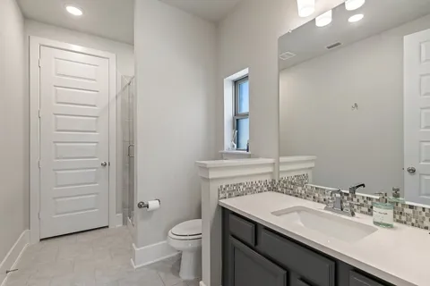 a bedroom with a bed television and a large window