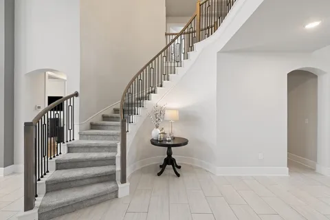 a bathroom with a granite countertop sink toilet and mirror