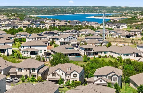 an aerial view of residential houses with outdoor space