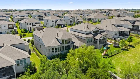an aerial view of multiple houses with a city view