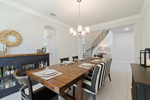a view of a dining room with furniture and chandelier
