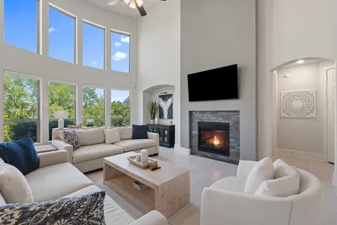 a living room with furniture a fireplace and a flat screen tv
