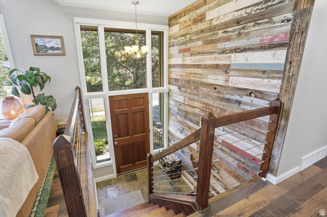 8938 Manchester Lane Sandy, UT 84093 - Photo 23 of 50 Entryway featuring a rich wood-paneled door, surrounding transom and sidelight windows, and a hanging chandelier