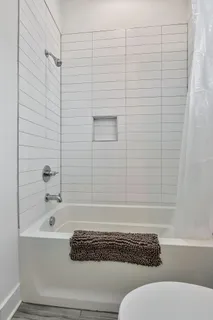 a bathroom with a bathtub and shower