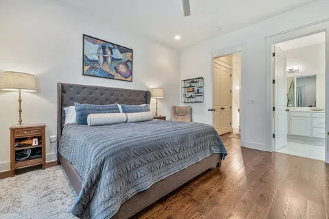 a bedroom with a bed and a painting on the wall